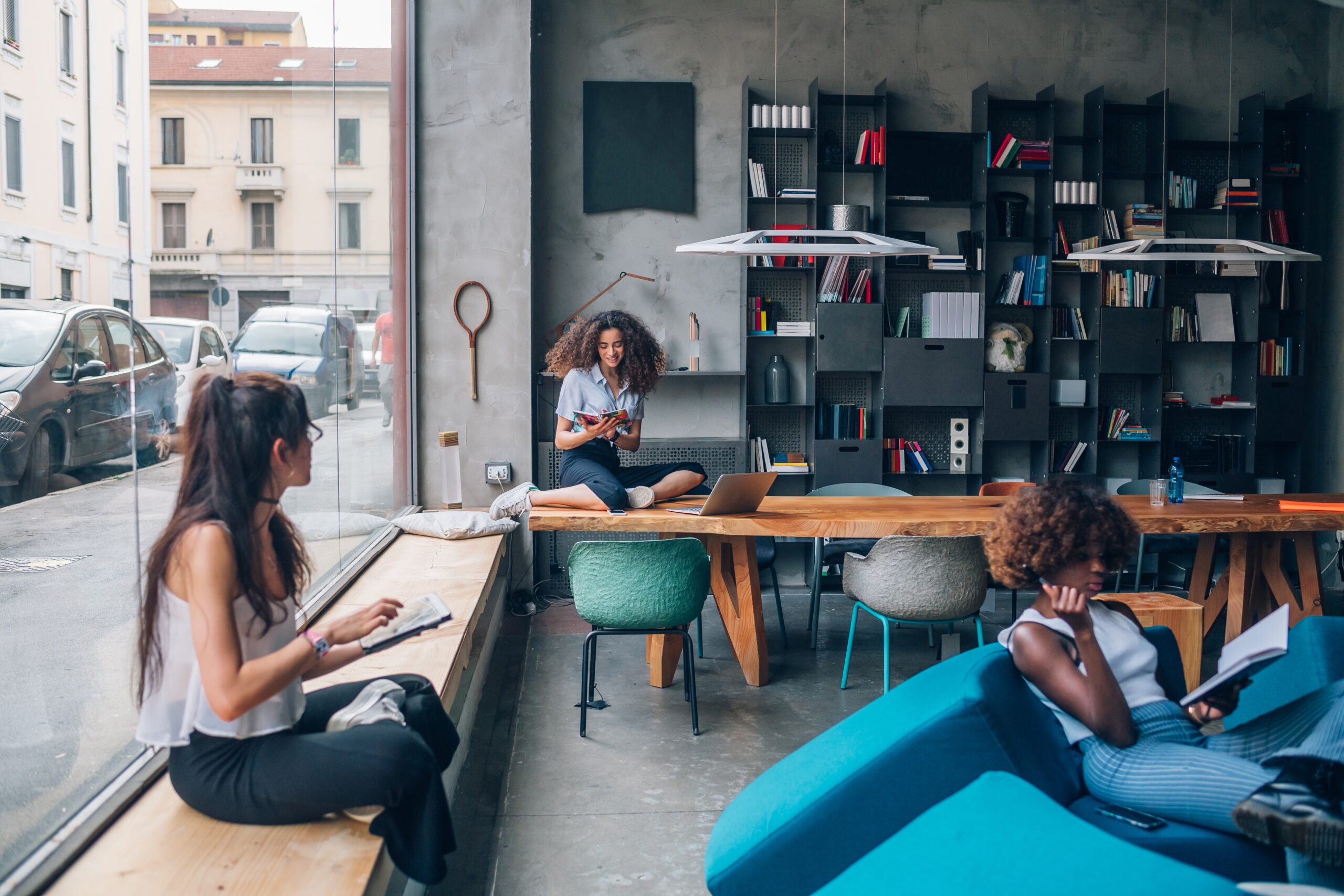 International professionals working and studying in a modern coworking space in Italy
