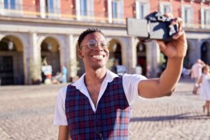 African-american man taking a selfie with his digital camera. young blogger taking a live selfie