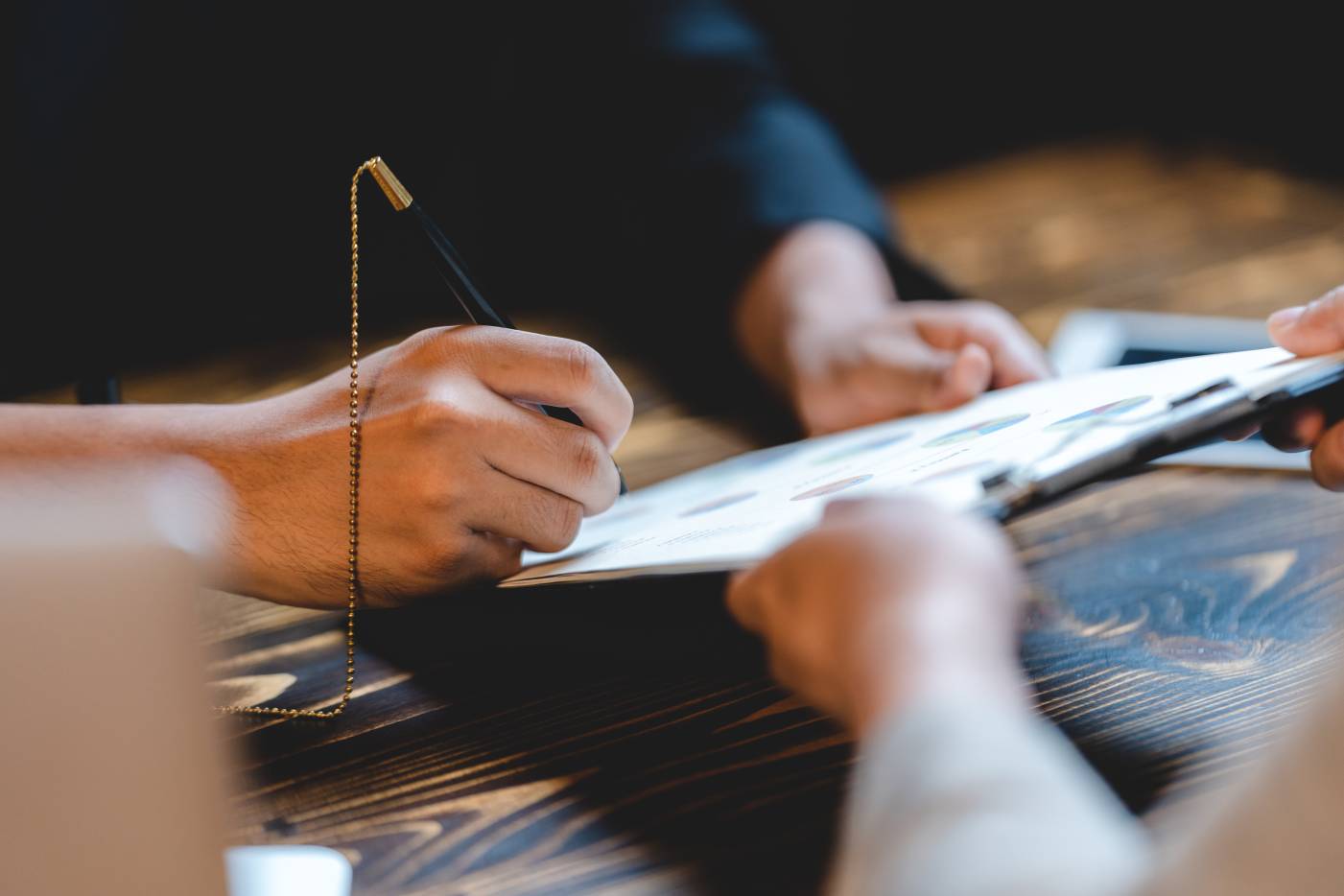 Holding a pen and signing a paper