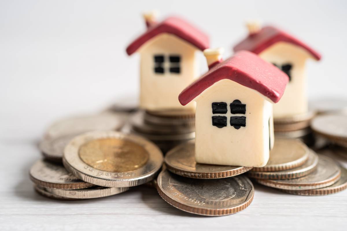 House on stack coins, mortgage home loan finance concept.