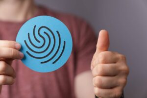 Man holding a sign of a fingerprint- the concept of privacy