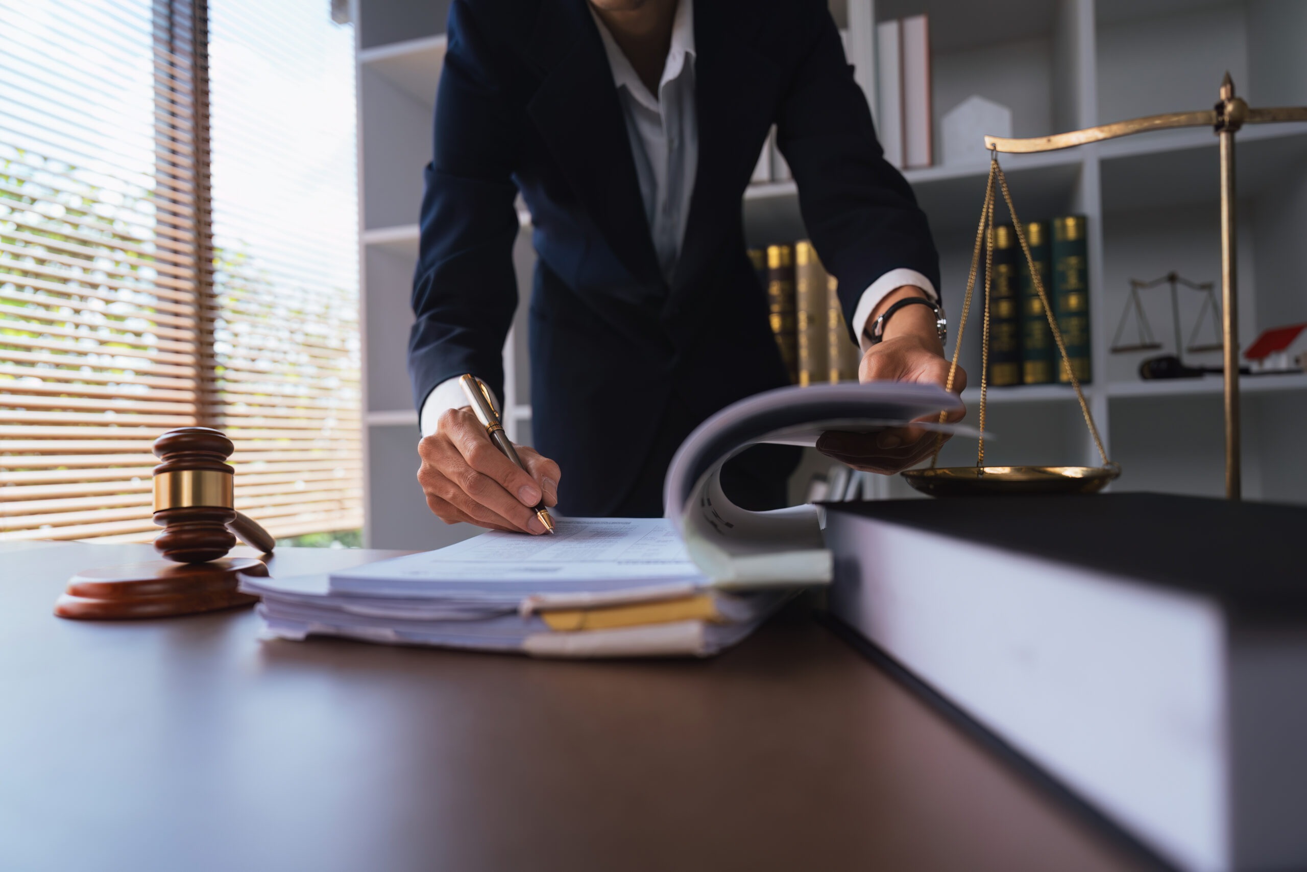 Legal professional reviewing official documents related to an Italian citizenship application at a desk