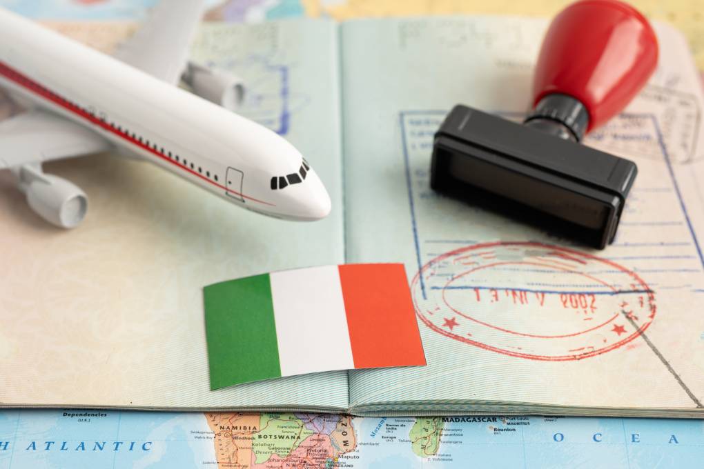 Approved Stamp visa and passport with Italy flag document to immigration at airport in country